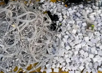 Discarded electronics and devices in e-waste recycling facility processing area - AP Photo/Jae C. Hong, File