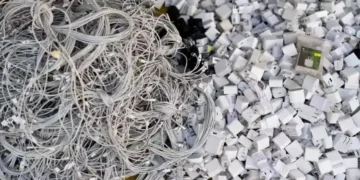 Discarded electronics and devices in e-waste recycling facility processing area - AP Photo/Jae C. Hong, File