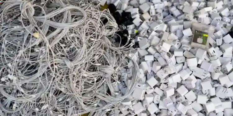 Discarded electronics and devices in e-waste recycling facility processing area - AP Photo/Jae C. Hong, File
