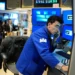 Oil barrels and stock market charts reflecting global price movements - AP Photo/Seth Wenig