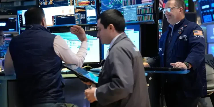 Traders monitor stock markets amid oil price volatility and global tensions - AP Photo/Seth Wenig