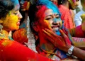 People throwing coloured powder during Holi festival in India - Getty Images