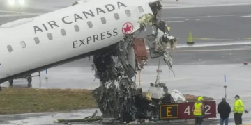 Damaged aircraft and fire truck after runway collision at LaGuardia Airport - AP Photo/Seth Wenig