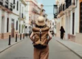 Woman travelling alone exploring scenic international destination safely - Oscar Wong/Getty Images