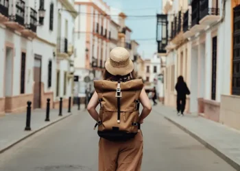 Woman travelling alone exploring scenic international destination safely - Oscar Wong/Getty Images