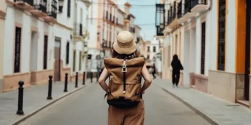 Woman travelling alone exploring scenic international destination safely - Oscar Wong/Getty Images