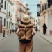 Woman travelling alone exploring scenic international destination safely - Oscar Wong/Getty Images