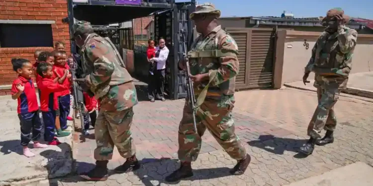 South African soldiers patrol Johannesburg streets during organized crime crackdown - AP Photo/Themba Hadebe