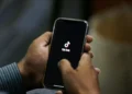 TikTok logo displayed on smartphone as U.S. ownership restructuring deal announced - AP Photo/Anjum Naveed, File