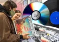 Vinyl records displayed with turntable highlighting physical music format appeal - Photo Headphonesty