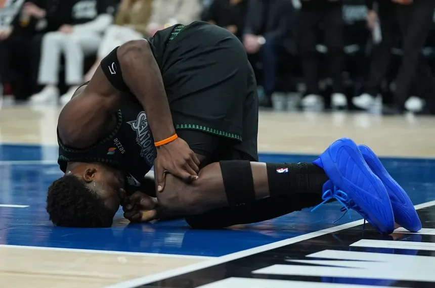 Anthony Edwards reacts after sustaining left knee injury during NBA playoff game - AP Photo/Abbie Parr