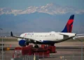 Delta aircraft as airline raises checked baggage fees - AP Photo/David Zalubowski, File