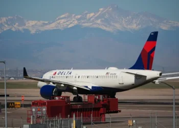 Delta aircraft as airline raises checked baggage fees - AP Photo/David Zalubowski, File