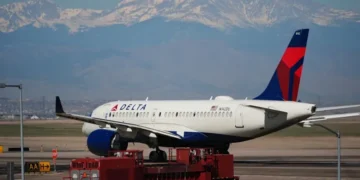 Delta aircraft as airline raises checked baggage fees - AP Photo/David Zalubowski, File
