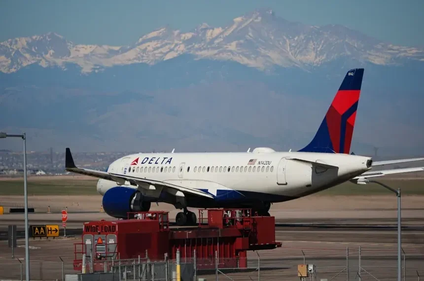 Delta aircraft as airline raises checked baggage fees - AP Photo/David Zalubowski, File