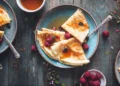 Different types of pancakes from around the world on plates - asab974/Adobe Stock via CNN