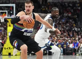 Nikola Jokic scoring during Nuggets overtime win against Timberwolves- AP Photo/David Zalubowski, File