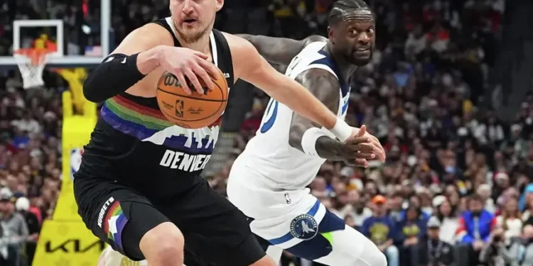 Nikola Jokic scoring during Nuggets overtime win against Timberwolves- AP Photo/David Zalubowski, File