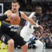 Nikola Jokic scoring during Nuggets overtime win against Timberwolves- AP Photo/David Zalubowski, File