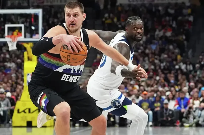 Nikola Jokic scoring during Nuggets overtime win against Timberwolves- AP Photo/David Zalubowski, File