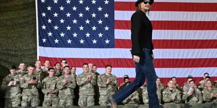 Kid Rock salutes as Army helicopters hover near Tennessee home - AP Photo/John Amis, File