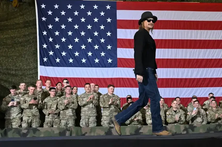 Kid Rock salutes as Army helicopters hover near Tennessee home - AP Photo/John Amis, File