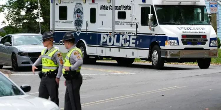 Police vehicles respond to park shooting in Winston-Salem North Carolina - AP Photo/Erik Verduzco