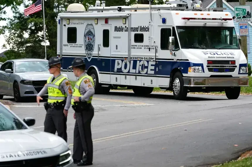 Police vehicles respond to park shooting in Winston-Salem North Carolina - AP Photo/Erik Verduzco