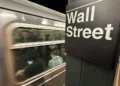 Oil pump jacks and stock market charts reflecting rising energy prices - AP Photo/Peter Morgan, File