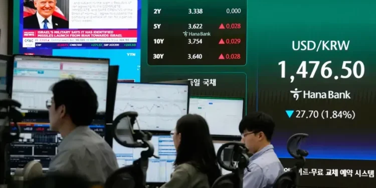 Traders monitor oil and equity screens after ceasefire rally - AP Photo/Ahn Young-joon