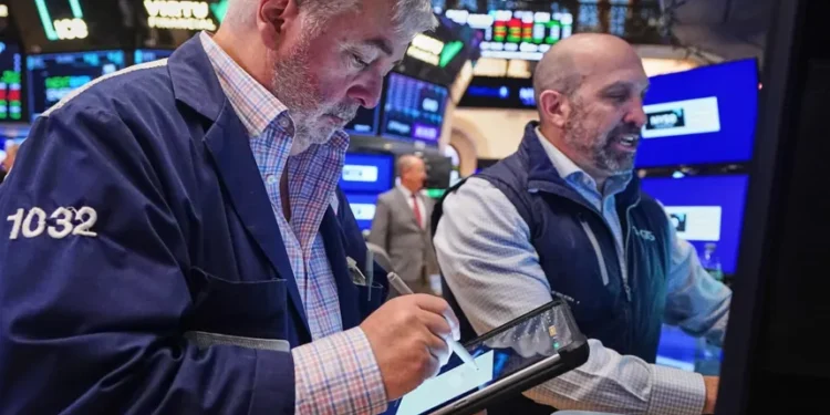Wall Street trading floor reacting to oil price surge and tech stock decline - AP Photo/Richard Drew