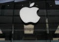 Apple logo with rising financial charts representing strong iPhone sales growth - AP Photo/Matthias Schrader, File