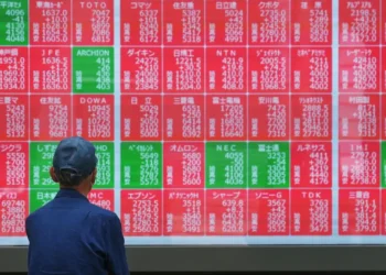 Traders monitor Asian stock markets after Wall Street reaches record highs - AP Photo/Eugine Hoshiko