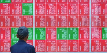 Traders monitor Asian stock markets after Wall Street reaches record highs - AP Photo/Eugine Hoshiko
