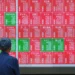 Traders monitor Asian stock markets after Wall Street reaches record highs - AP Photo/Eugine Hoshiko