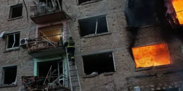 Emergency crews respond after Russian missile strikes in Kyiv amid Belarus tensions - AP Photo/Evgeniy Maloletka