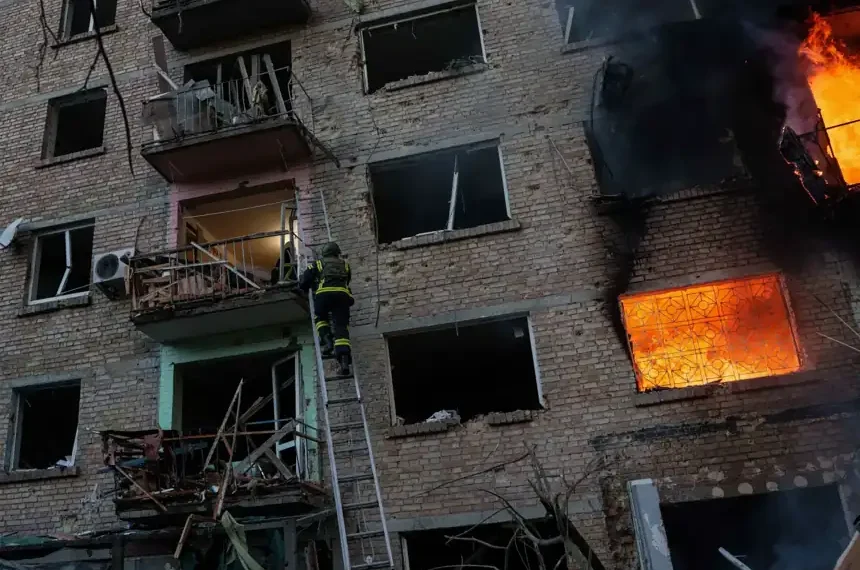 Emergency crews respond after Russian missile strikes in Kyiv amid Belarus tensions - AP Photo/Evgeniy Maloletka
