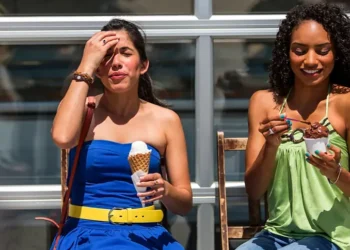 Person experiencing brain freeze after eating ice cream quickly - Credit: Getty Images