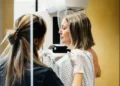 Researcher reviewing breast cancer genomic testing results in laboratory - Credit: Getty Images