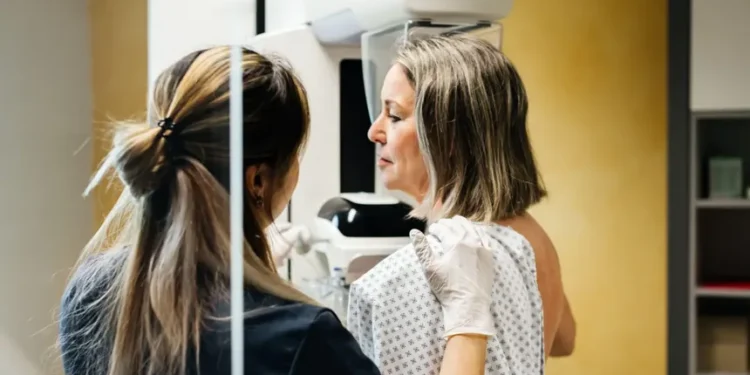 Researcher reviewing breast cancer genomic testing results in laboratory - Credit: Getty Images