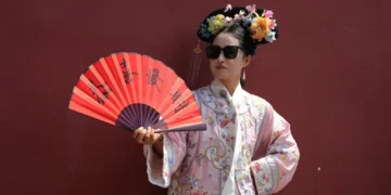 Visitors wearing imperial Chinese costumes near Beijing’s Forbidden City - AP Photo/Ng Han Guan