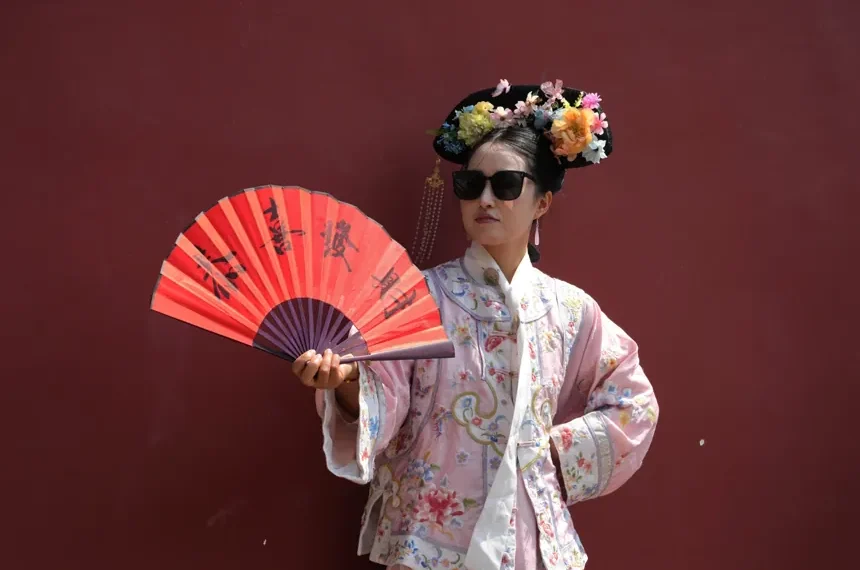 Visitors wearing imperial Chinese costumes near Beijing’s Forbidden City - AP Photo/Ng Han Guan
