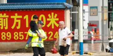 Rescue workers evacuate residents during severe flooding in China - Xiao Wei/Xinhua via AP