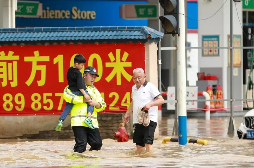 Rescue workers evacuate residents during severe flooding in China - Xiao Wei/Xinhua via AP