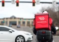 DoorDash delivery driver during rising fuel cost pressures in the U.S. - AP Photo/David Zalubowski, File