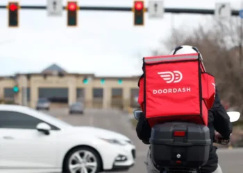 DoorDash delivery driver during rising fuel cost pressures in the U.S. - AP Photo/David Zalubowski, File