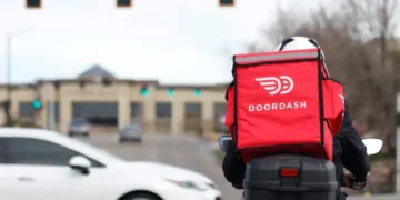DoorDash delivery driver during rising fuel cost pressures in the U.S. - AP Photo/David Zalubowski, File