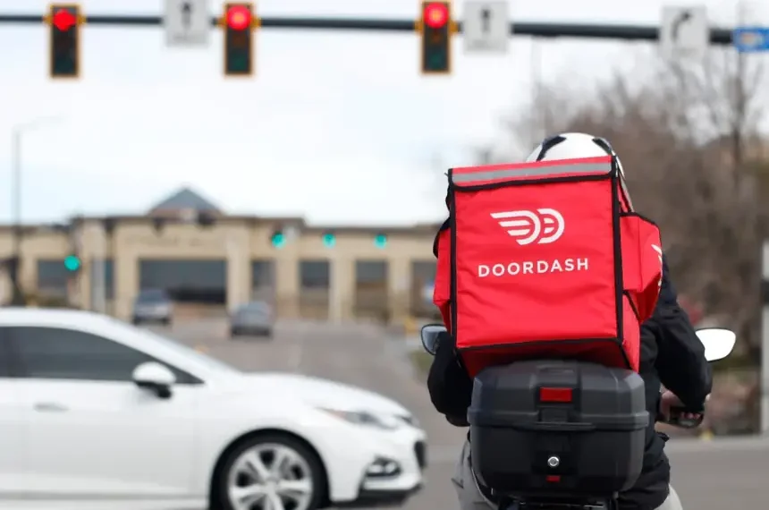 DoorDash delivery driver during rising fuel cost pressures in the U.S. - AP Photo/David Zalubowski, File