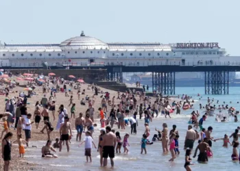 People seek shade during record-breaking heat wave in Europe - Gareth Fuller/PA via AP