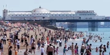 People seek shade during record-breaking heat wave in Europe - Gareth Fuller/PA via AP